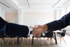 Photo of handshake in a conference room