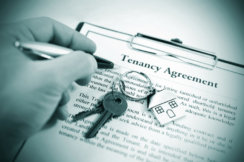 Photo of keys and Tenancy Agreement being signed